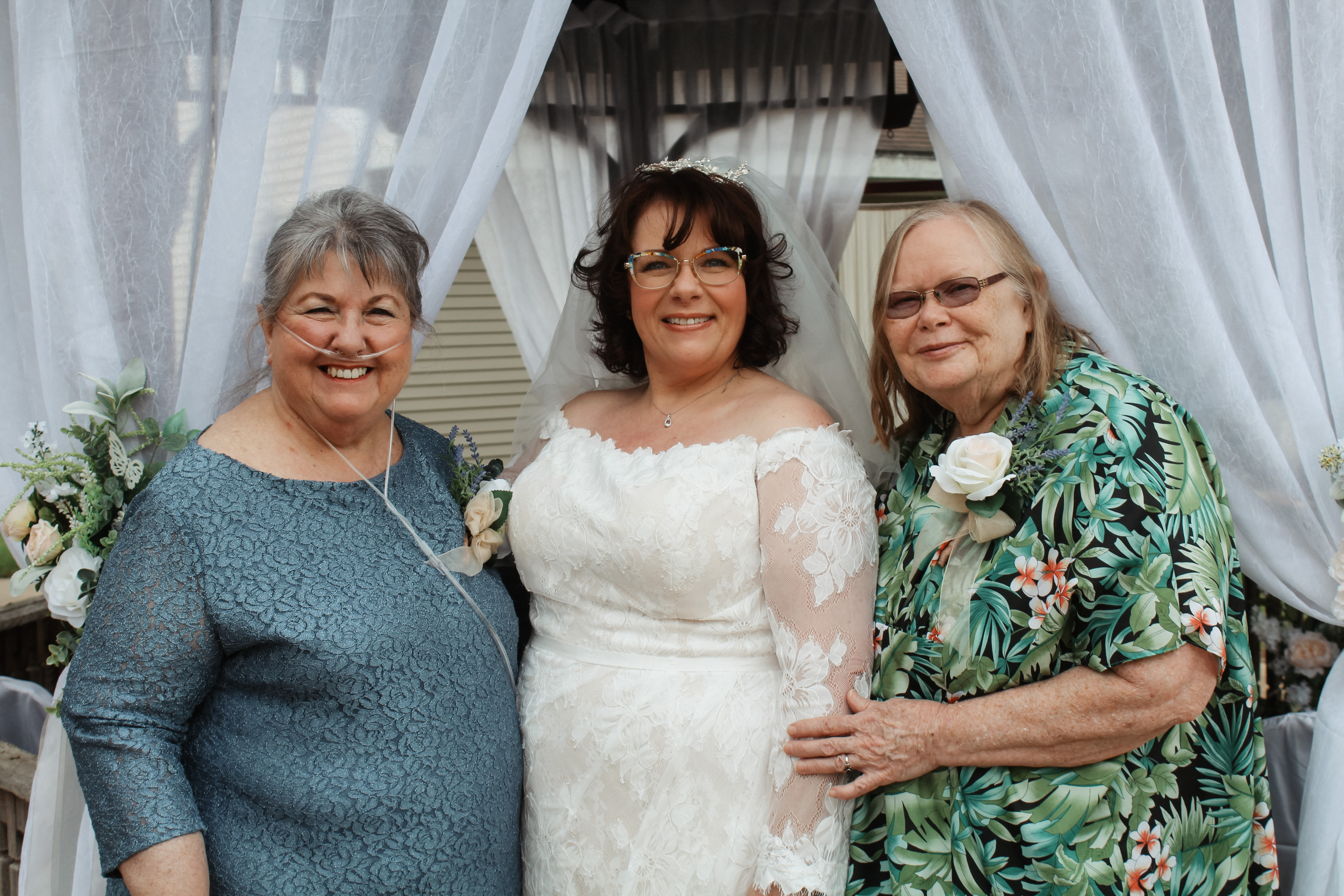 Bride with her two mothers or elder family members, wedding family portrait