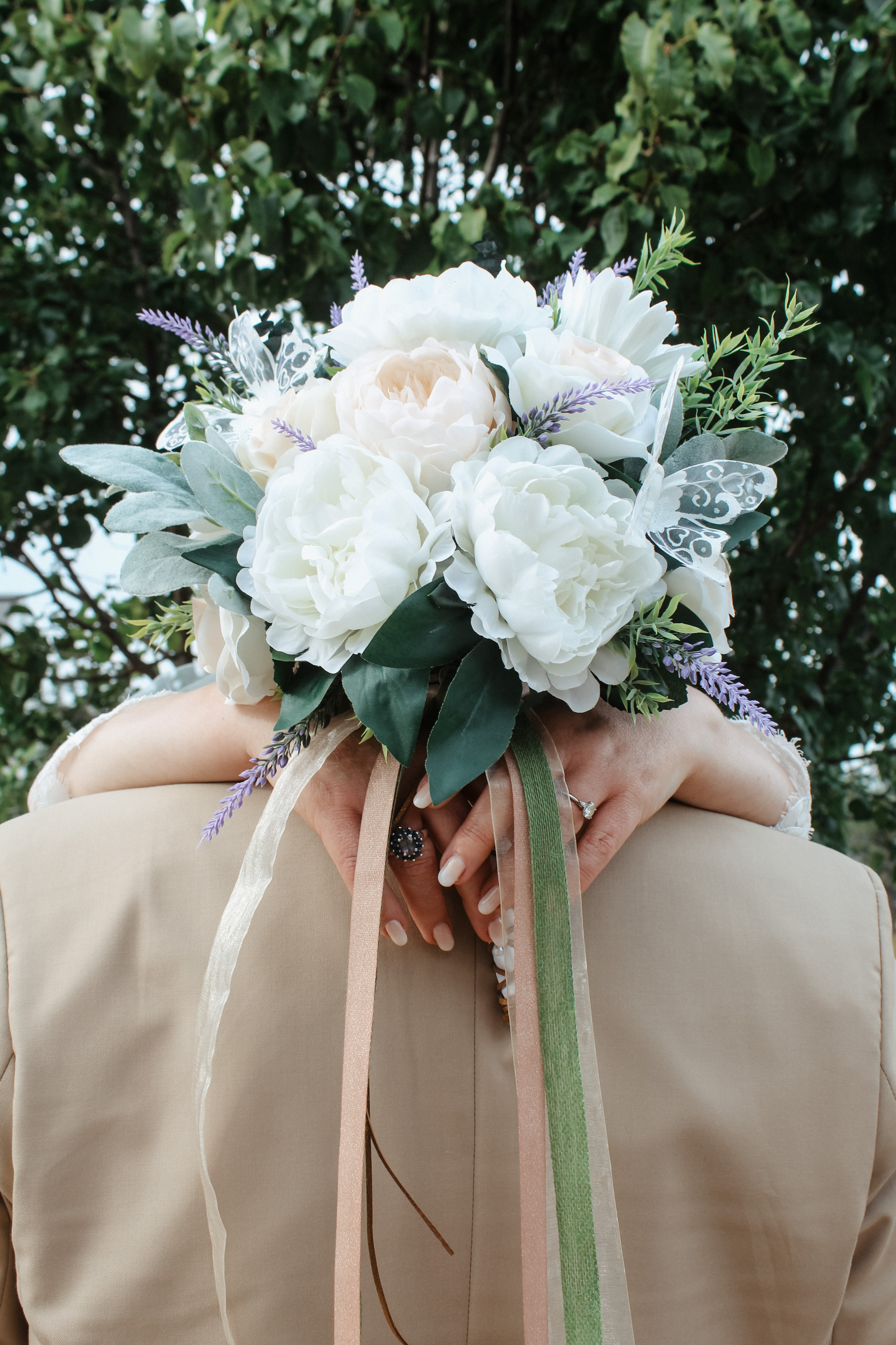 Bride holding wedding bouquet with ribbon streamers, wedding portrait detail photo