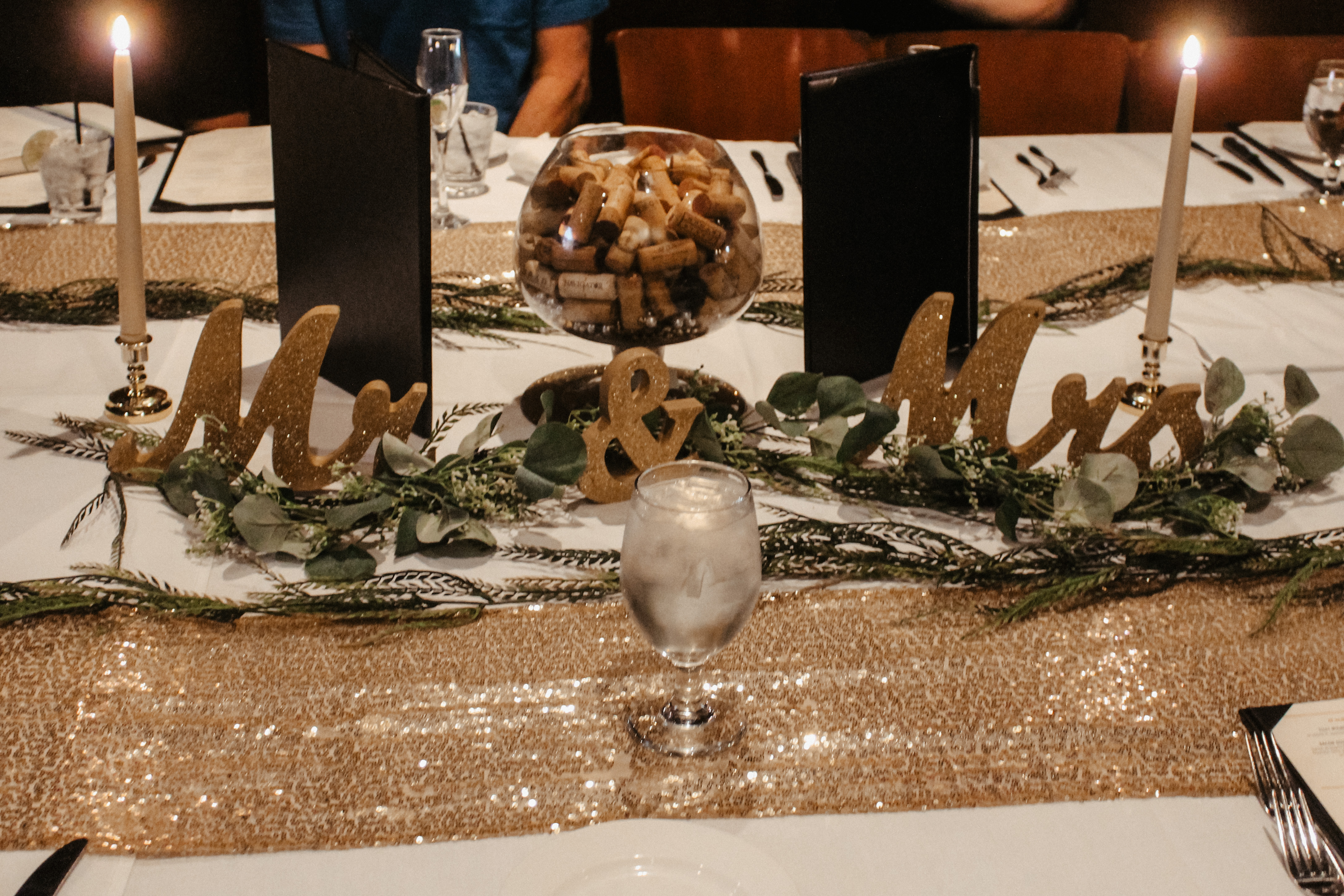 Mr and Mrs table setting, wedding head table with greenery and cork centerpiece