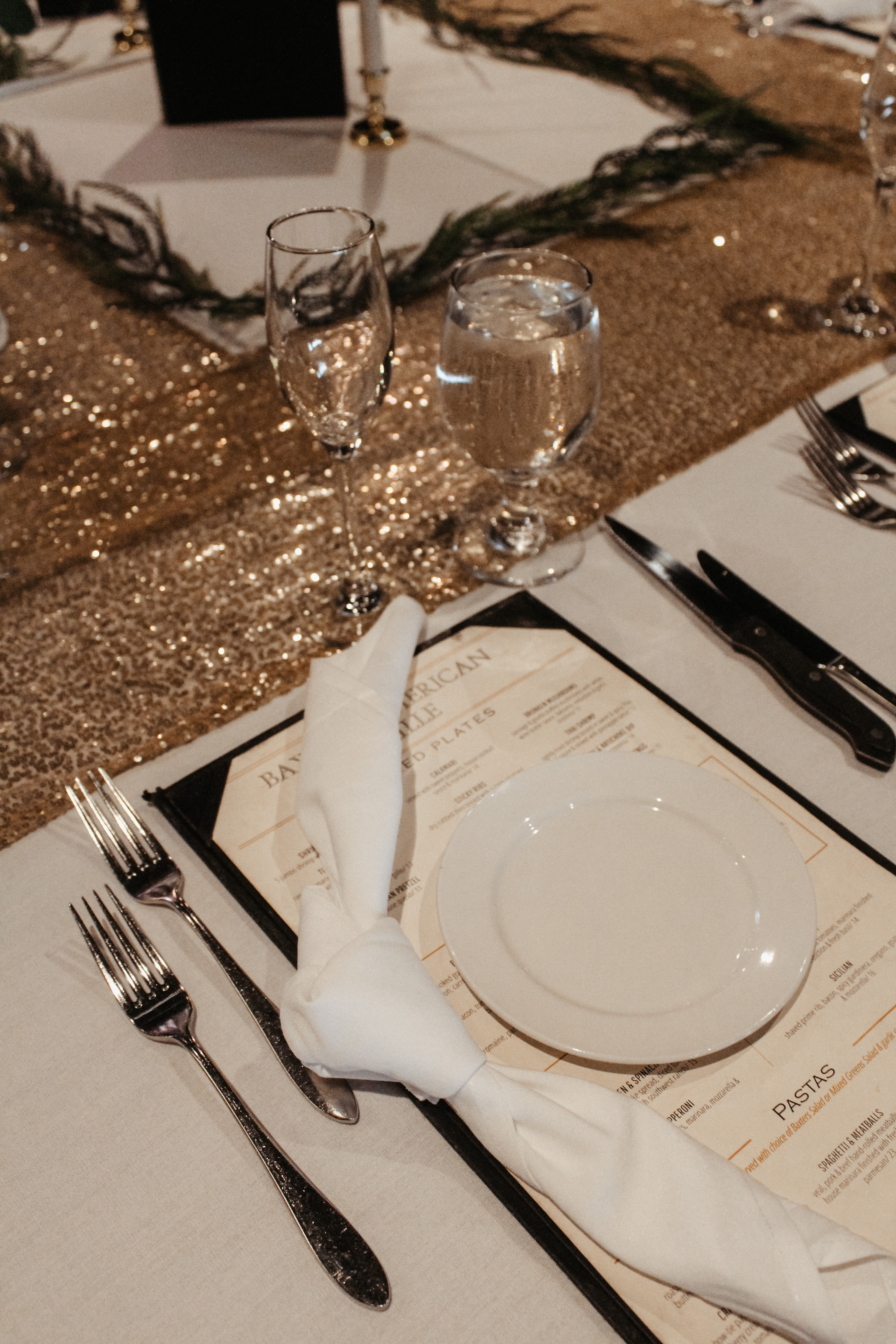 Elegant table setting at wedding reception with sequin table runner and custom menu